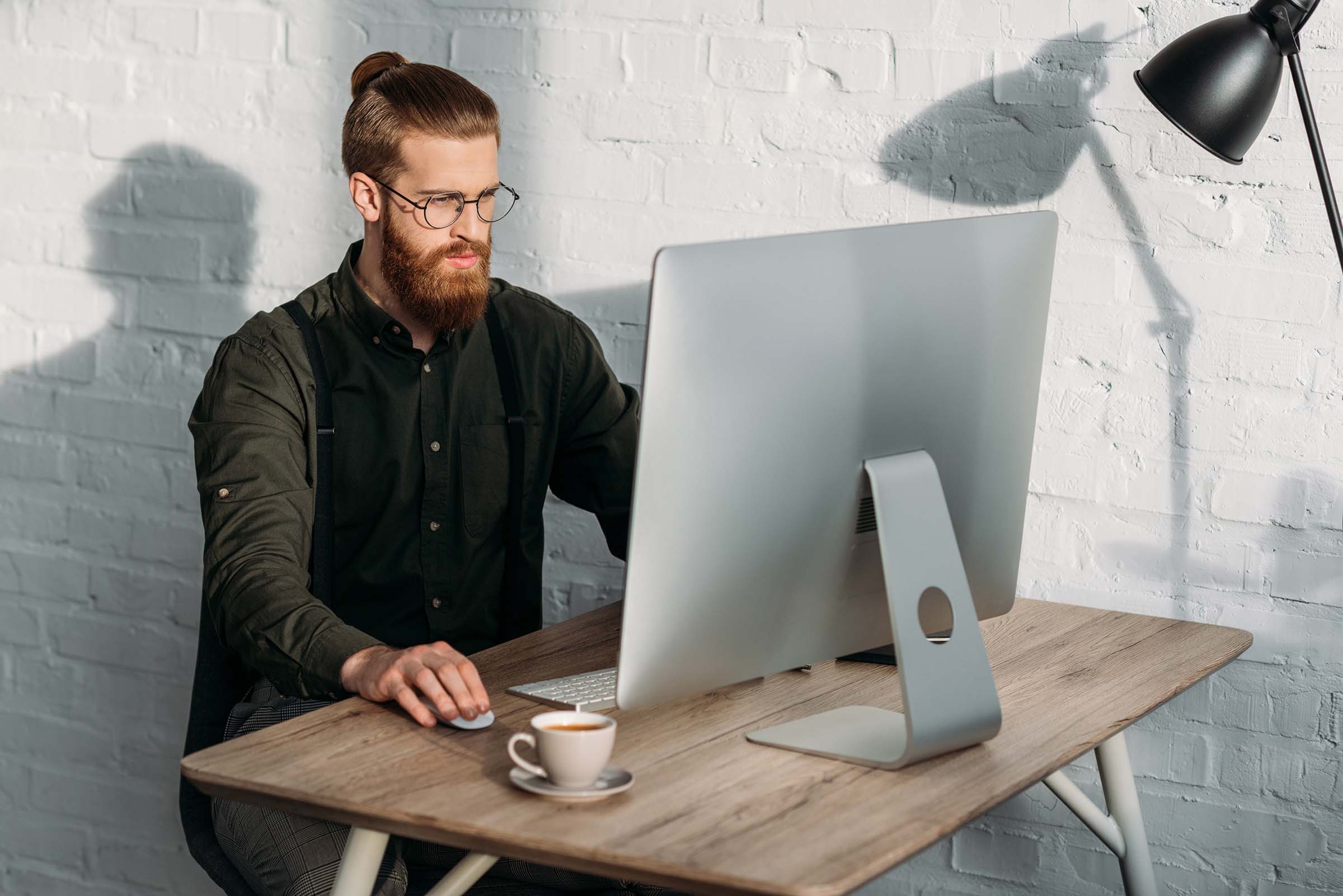 handsome-businessman-working-with-computer-in-offi-DGCFY9K.jpg